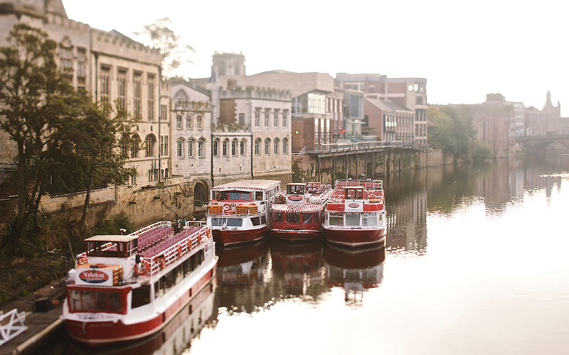 Boats docked on River Ouse in York